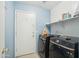 Bright laundry room featuring side-by-side washer and dryer with overhead shelving at 2401 E Antigua Dr, Casa Grande, AZ 85194