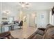 Open-concept living room featuring tile floors, a ceiling fan, and a comfortable leather sofa at 2401 E Antigua Dr, Casa Grande, AZ 85194