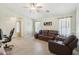 Bright living room with tile flooring, natural light, and a comfortable reclining leather sofa at 2401 E Antigua Dr, Casa Grande, AZ 85194