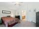 Bright main bedroom featuring neutral walls, carpet, a ceiling fan, and an ensuite bathroom with modern fixtures at 2401 E Antigua Dr, Casa Grande, AZ 85194