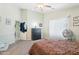 Bright main bedroom featuring neutral walls, carpet, a ceiling fan, and a walk-in closet at 2401 E Antigua Dr, Casa Grande, AZ 85194