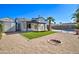 Landscaped backyard features artificial turf, gravel, a fire pit, a covered patio, and a fenced in pool at 2421 E Dragoon Ave, Mesa, AZ 85204