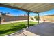 Relaxing backyard featuring low-maintenance artificial turf and shaded patio space at 2421 E Dragoon Ave, Mesa, AZ 85204