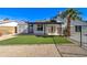 Backyard showing the covered patio, patch of grass, and a gravel area with a shed at 2421 E Dragoon Ave, Mesa, AZ 85204