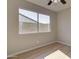 Bedroom featuring new floors and a window view of the backyard privacy wall at 2421 E Dragoon Ave, Mesa, AZ 85204
