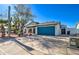 Inviting single-story home with desert landscaping and a striking blue garage door for added curb appeal at 2421 E Dragoon Ave, Mesa, AZ 85204