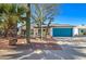 Charming home featuring desert landscaping, a blue garage door, and a well-maintained front yard at 2421 E Dragoon Ave, Mesa, AZ 85204