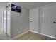 Hallway with wood floors, closet and white doors, and a security monitoring system at 2421 E Dragoon Ave, Mesa, AZ 85204