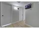 Hallway featuring multiple white doors, wood floors, and security monitoring system at 2421 E Dragoon Ave, Mesa, AZ 85204