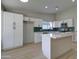 Bright kitchen with white cabinets, subway tile backsplash, and quartz countertops at 2421 E Dragoon Ave, Mesa, AZ 85204