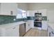 Well-appointed kitchen with stainless steel appliances and stylish subway tile backsplash at 2421 E Dragoon Ave, Mesa, AZ 85204
