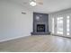 Light-filled living room showcasing a cozy fireplace and French doors to the backyard at 2421 E Dragoon Ave, Mesa, AZ 85204
