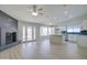 Open-concept layout connects the living room, fireplace, and kitchen with white cabinets at 2421 E Dragoon Ave, Mesa, AZ 85204
