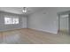 Bright living room with natural light, wood-look floors, and a view of the community at 2421 E Dragoon Ave, Mesa, AZ 85204