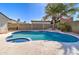 Swimming pool with connected spa, surrounded by concrete decking and desert landscaping at 2421 E Dragoon Ave, Mesa, AZ 85204