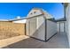 Shed with gray shingle roof, white painted exterior, and a lattice accent at 2421 E Dragoon Ave, Mesa, AZ 85204
