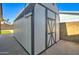 Durable outdoor storage shed with access door and secure siding for protecting tools and equipment at 2421 E Dragoon Ave, Mesa, AZ 85204