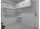 Bright utility room with shelving, cabinets and white walls, ideal for storage solutions at 2421 E Dragoon Ave, Mesa, AZ 85204