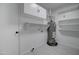Utility room with shelving, cabinets, water heater and white walls at 2421 E Dragoon Ave, Mesa, AZ 85204