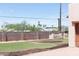 Brick wall surrounds a grassy yard with custom planters at 2430 N 56Th St, Phoenix, AZ 85008