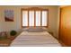 Bedroom featuring a window with shutters and comfortable furnishings at 2430 N 56Th St, Phoenix, AZ 85008