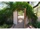 Courtyard entrance with a brick path leading to a shaded walkway framed by greenery at 2430 N 56Th St, Phoenix, AZ 85008
