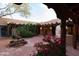 Expansive courtyard with a fountain, mature trees, and architectural details with cozy lighting at 2430 N 56Th St, Phoenix, AZ 85008