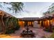 Charming courtyard with brick pavers, a central fountain, and lush greenery creating a serene outdoor living space at 2430 N 56Th St, Phoenix, AZ 85008