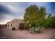 Charming southwestern home featuring desert landscaping, a mature tree, and a neutral color palette at 2430 N 56Th St, Phoenix, AZ 85008