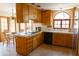 Kitchen featuring wooden cabinets, tile countertops, and modern appliances at 2430 N 56Th St, Phoenix, AZ 85008