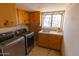 Laundry room with washer, dryer, and storage cabinets at 2430 N 56Th St, Phoenix, AZ 85008