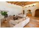Inviting living room featuring a stone fireplace, light-colored couches, and a warm, welcoming ambiance at 2430 N 56Th St, Phoenix, AZ 85008