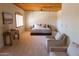 Spacious main bedroom featuring a wooden ceiling, carpet, and comfortable seating area at 2430 N 56Th St, Phoenix, AZ 85008