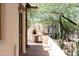 Outdoor pizza oven and kitchen on a charming patio with brick flooring, shaded by greenery at 2430 N 56Th St, Phoenix, AZ 85008
