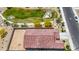 An aerial view of a home, showcasing its tile roof, a spacious backyard, and its proximity to a park at 24559 W Flores Dr, Buckeye, AZ 85326