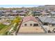 An aerial view of a home featuring a spacious backyard, surrounded by a vibrant community and mountain views at 24559 W Flores Dr, Buckeye, AZ 85326