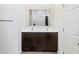 Modern bathroom featuring a double sink vanity with dark wood cabinets and a large mirror at 24559 W Flores Dr, Buckeye, AZ 85326