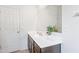 Bathroom vanity with white countertop, undermount sink, and ample lighting at 24559 W Flores Dr, Buckeye, AZ 85326