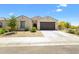 Charming single-story home features a two-car garage and low-maintenance desert landscaping at 24559 W Flores Dr, Buckeye, AZ 85326