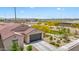 An exterior image with desert landscaping in front of a home and with a park-like field in the background at 24559 W Flores Dr, Buckeye, AZ 85326