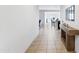 Inviting hallway leads to an open-concept living area with tiled flooring and natural light at 24559 W Flores Dr, Buckeye, AZ 85326