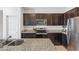 Well-equipped kitchen with granite countertops, stainless steel appliances, and ample cabinetry at 24559 W Flores Dr, Buckeye, AZ 85326