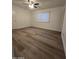 Bedroom features new floors, a ceiling fan and a window with blinds at 2544 N 52Nd Ave, Phoenix, AZ 85035