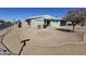 Charming single-story home featuring a xeriscaped yard, gray paint, and a black garage door at 2544 N 52Nd Ave, Phoenix, AZ 85035