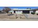 Charming single-story home featuring a xeriscaped yard, gray paint, and a black garage door at 2544 N 52Nd Ave, Phoenix, AZ 85035