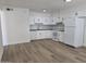 Modern kitchen featuring white cabinets, subway tile backsplash, and hardwood floors at 2544 N 52Nd Ave, Phoenix, AZ 85035