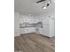 Modern kitchen featuring white cabinets, subway tile backsplash, and hardwood floors at 2544 N 52Nd Ave, Phoenix, AZ 85035