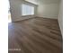 Bright living room featuring hardwood floors, neutral paint, and large windows at 2544 N 52Nd Ave, Phoenix, AZ 85035