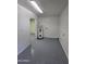 Utility room with water heater, painted walls, and a light gray concrete floor at 2544 N 52Nd Ave, Phoenix, AZ 85035