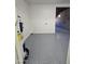 Utility room with speckled floor and modern water heater at 2544 N 52Nd Ave, Phoenix, AZ 85035